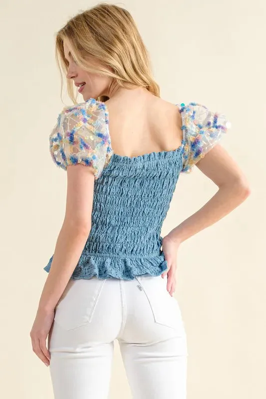 Blue Smocked Top with Multicolor Floral Puff Sleeves – Ruffled Hem Detail