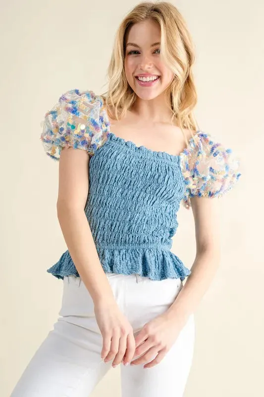 Blue Smocked Top with Multicolor Floral Puff Sleeves – Ruffled Hem Detail
