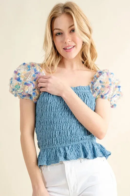 Blue Smocked Top with Multicolor Floral Puff Sleeves – Ruffled Hem Detail